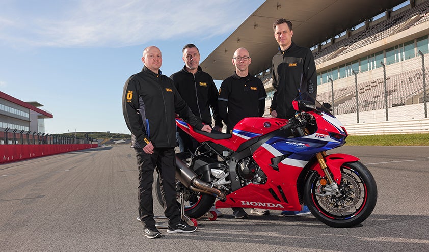 Red Honda CBR1000RR-R 2024 motorcycle equipped with Öhlins Suspension parked on racetrack with Öhlins Managers.